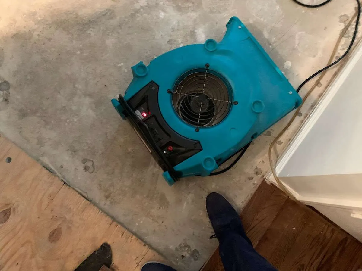 Air mover drying subfloor during Leak Detection & Repair in Topsham